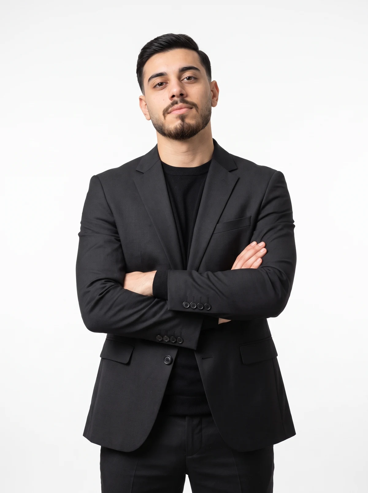 Mohammad Fneish in a black suit with his arms crossed